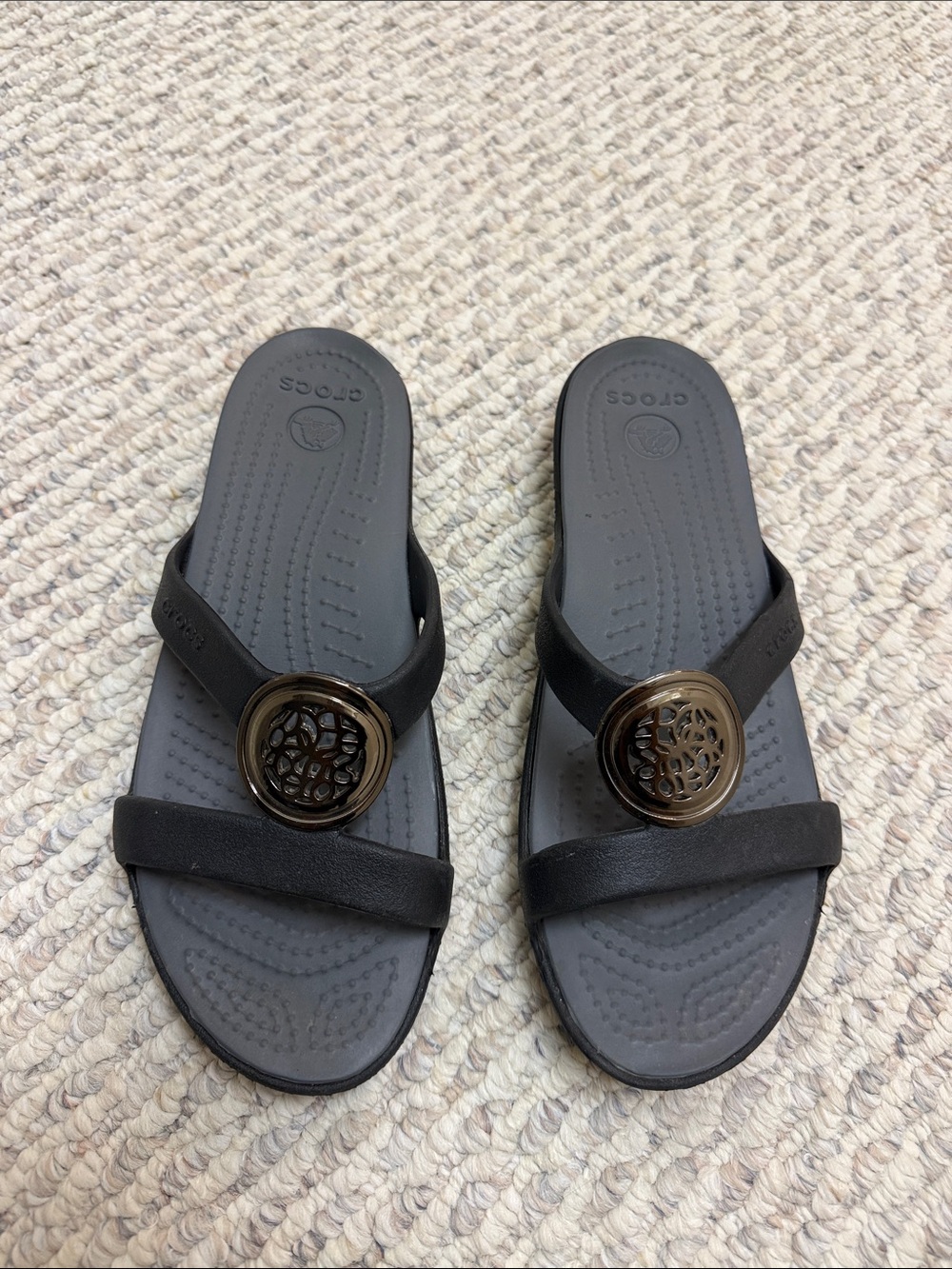 CROCS Women’s Black Slide Sandals with Bronze Decorative Medallion
